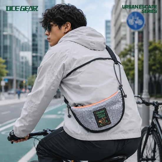 Urban commuter wearing OCE GEAR Cloud Shadow Half Moon Bag in city cycling scene
