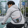 Urban commuter wearing OCE GEAR Cloud Shadow Half Moon Bag in city cycling scene