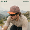 Cyclist wearing OCE GEAR Spark Lightweight Foldable Trail Cap on mountain road