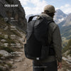 Hiker wearing OCE GEAR 55L roll-top backpack on a mountain trail