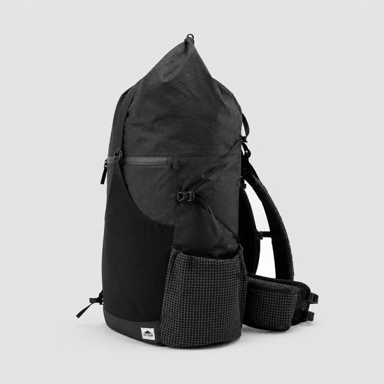 Side view of black roll-top hiking backpack with side pocket and adjustable gear cords