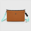 Rear view of OCE GEAR Trail Orange crossbody organizer bag with snap pocket