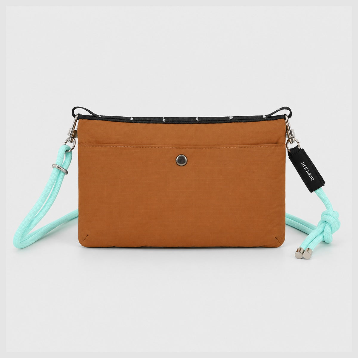 Rear view of OCE GEAR Trail Orange crossbody organizer bag with snap pocket