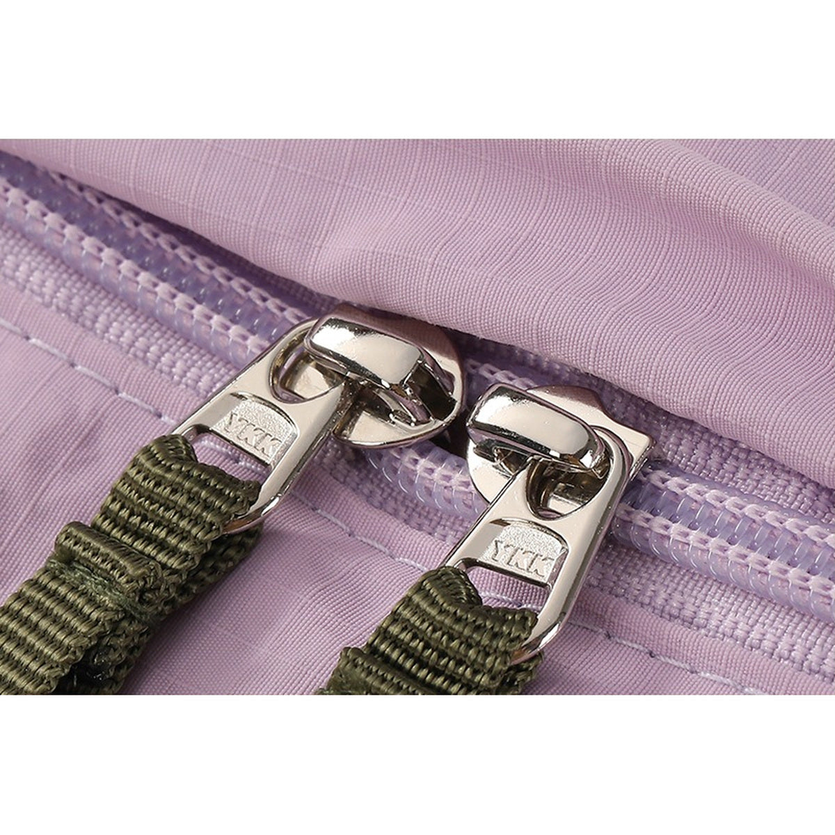 Close-up of metal zipper sliders with olive webbing zipper pulls