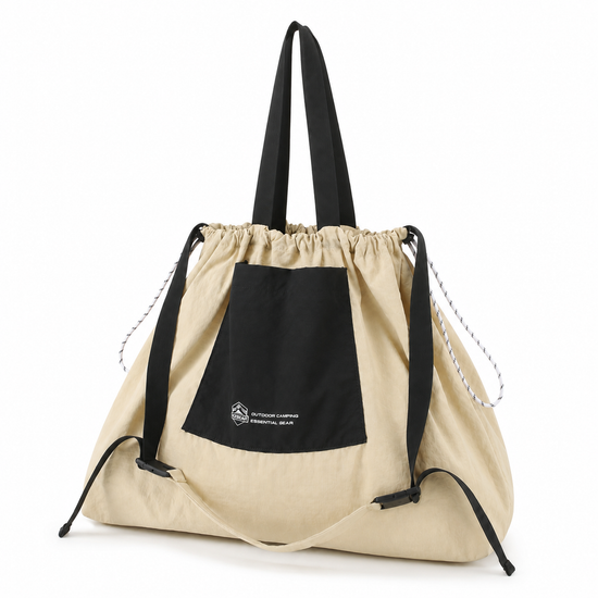 Cream black foldable travel drawstring tote bag angled view