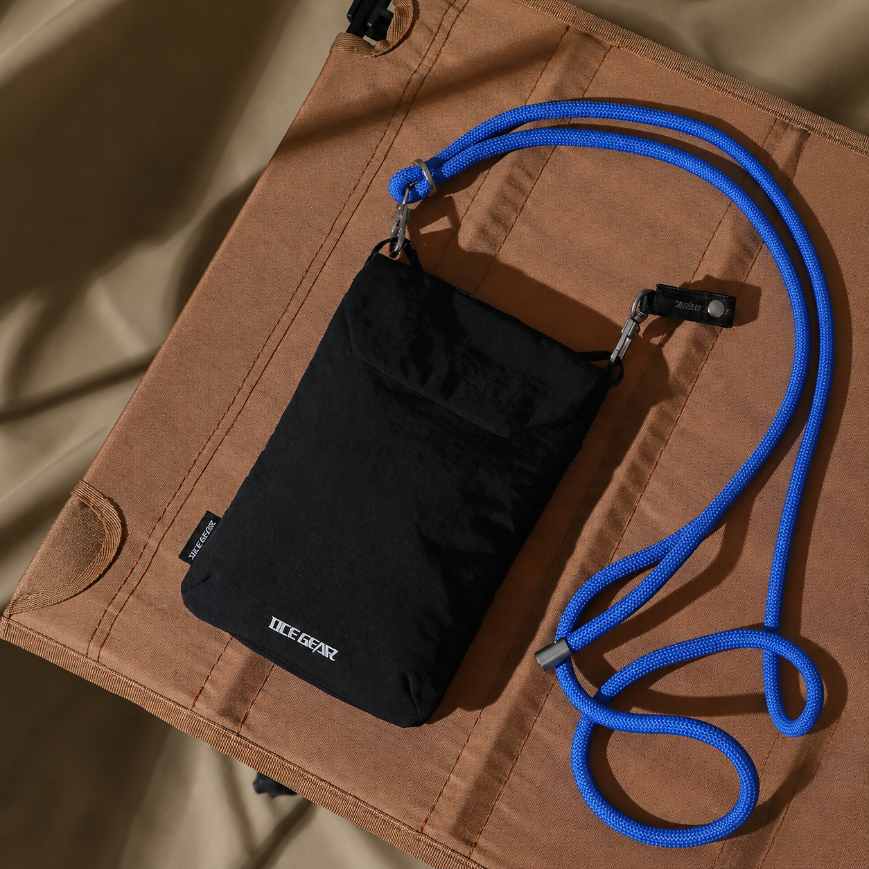 Black RFID travel phone pouch with detachable blue rope strap