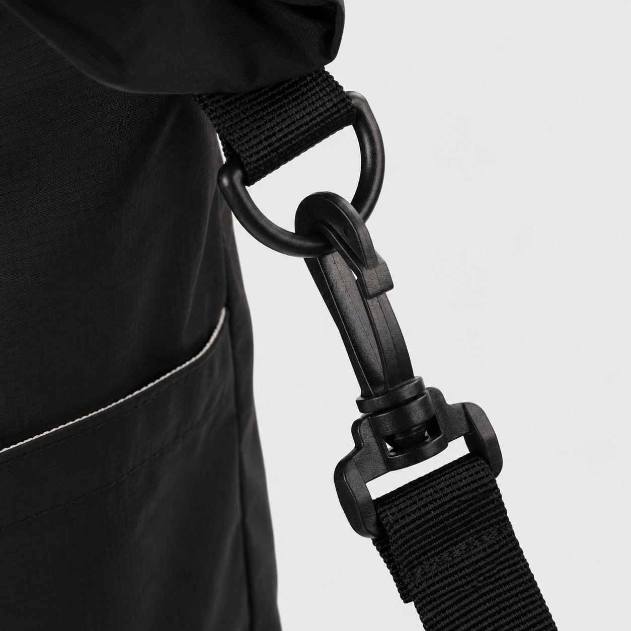 Rotating quick release clip detail on packable travel tote bag
