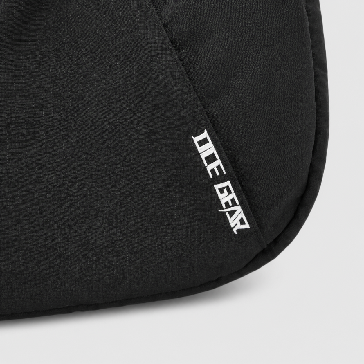 OCE GEAR logo detail on black expandable crescent shoulder bag